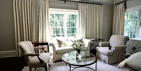 A cozy living room featuring a glass coffee table