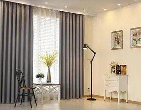A cozy room featuring elegant gray curtains