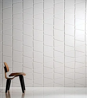 A modern wooden chair in front of a geometric textured wall