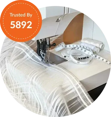 A sewing machine in action with white fabric