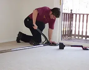 A technician kneeling on the floor