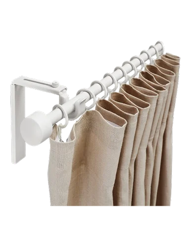 Close-up of a beige curtain hanging from a sleek white rod