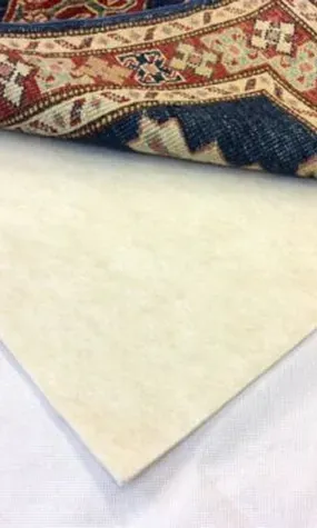 Close-up of a colorful patterned fabric folded over a plain beige sheet