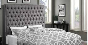 Cozy bedroom featuring a tufted gray headboard