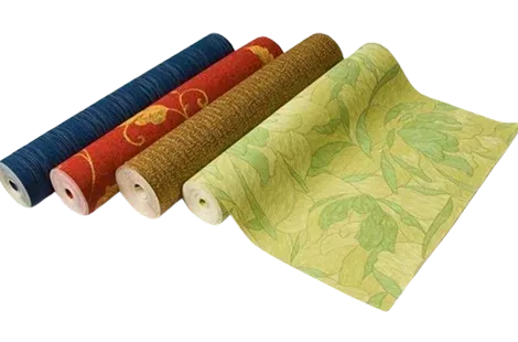 Four rolls of decorative fabric in various colors and patterns