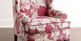 Intricately patterned armchair featuring a floral design in shades