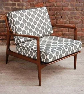 Mid-century modern armchair with a patterned gray and white cushion