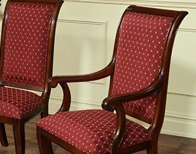 Two elegant wooden chairs with red patterned upholstery
