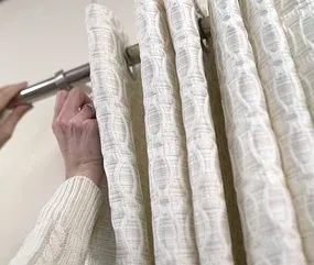 person's hands adjust a textured, light-colored