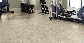 spacious gym interior with light-colored flooring